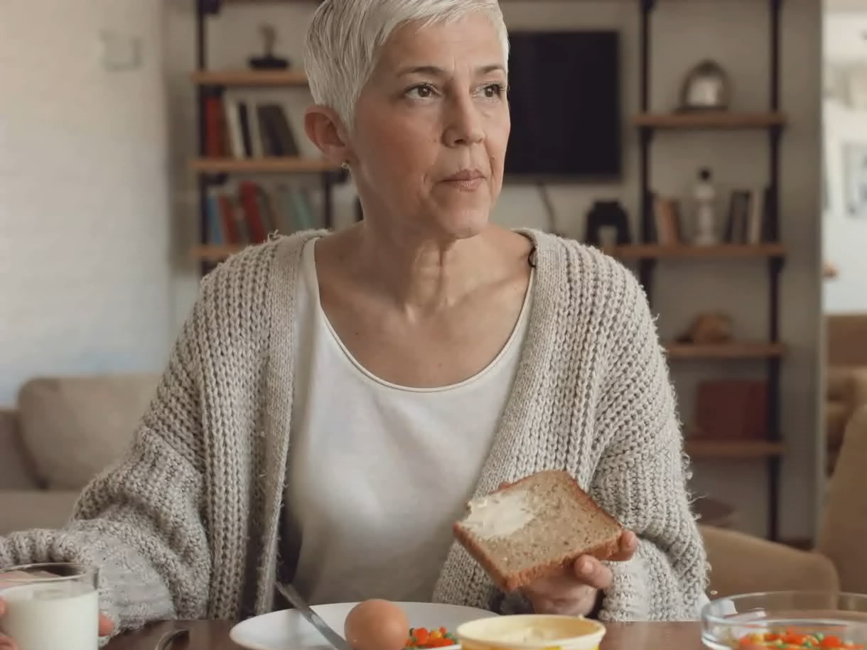 An older woman having breakfast at home on an ordinary morning.